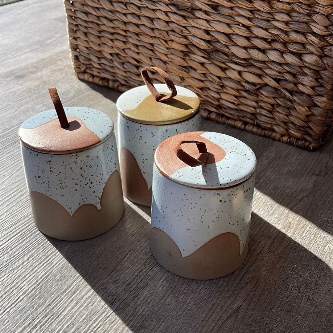 Stoneware canister with leather loop and reactive glaze